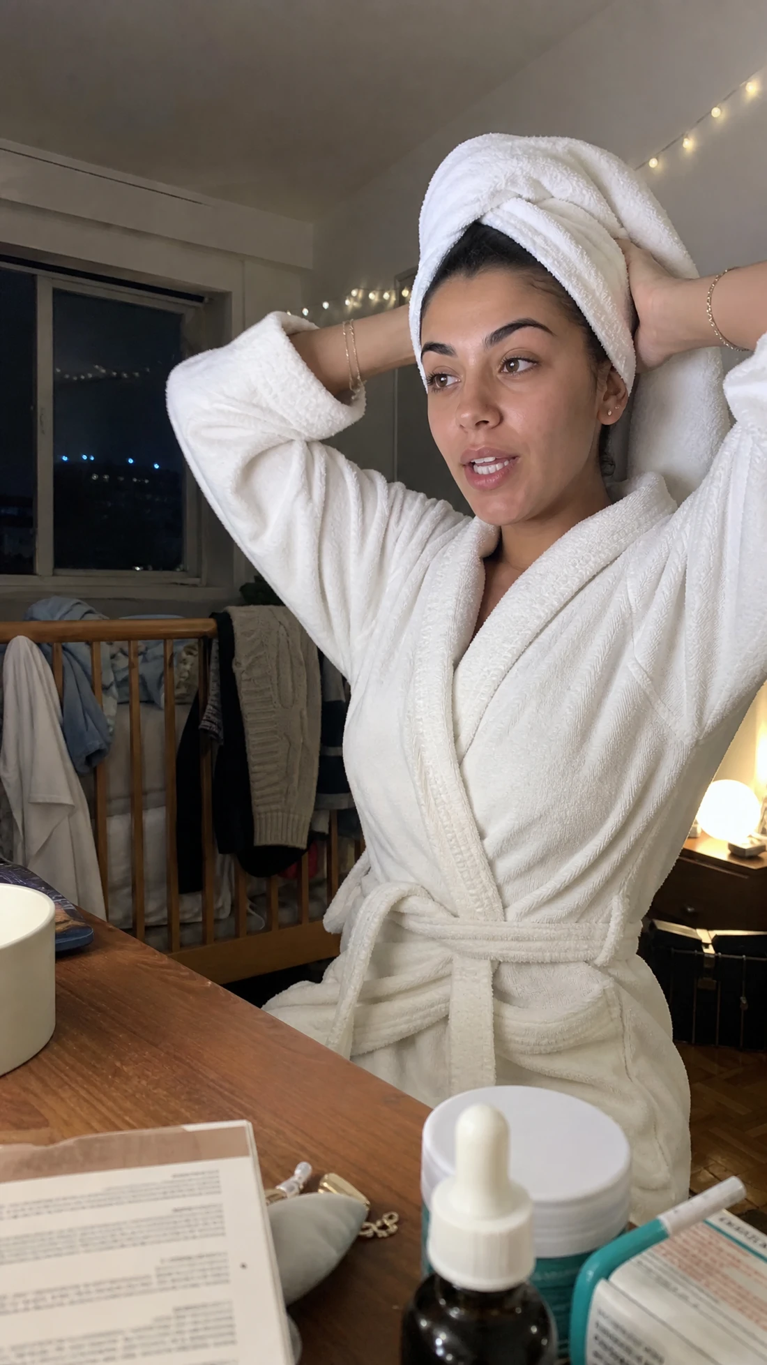 Text-only UGC Tripod Styler result showing a woman at a dresser in a realistic fixed phone shot